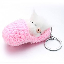 Sleeping cat in a hand-woven cot - keychainKeyrings