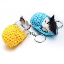 Sleeping cat in a hand-woven cot - keychainKeyrings