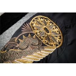 Black bomber jacket with embroidered golden wingsJackets